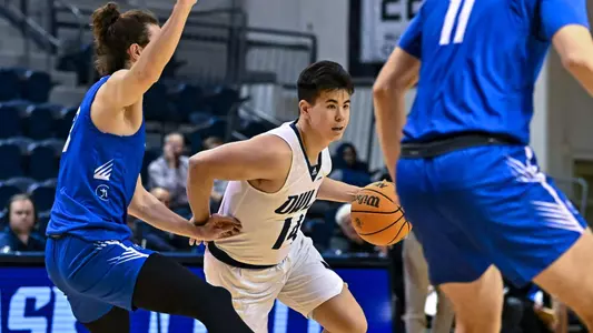 October 31, 2022: Rice Owls guard Reed Myers (14) controls the ball in the second half against the Rockhurst Hawks at Tudor Fieldhouse in Houston, Texas. Mandatory Credit: Maria Lysaker | Rice Athletics