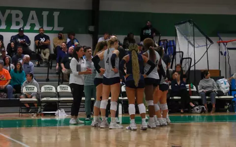 Rice volleyball huddles up during a timeout of a recent match