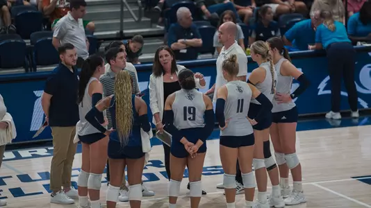 Rice volleyball huddles up during a timeout of a recent match