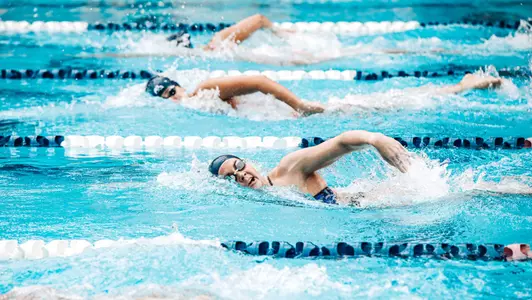 Rice swimmers compete in a freestyle race during a recent home meet