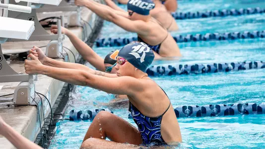 A Rice swimmer sets up for the start of a backstroke event at a recent meet.
