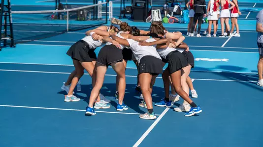 The Rice women's tennis team huddles up before the start of a recent match