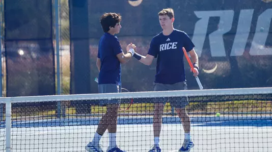 Rice men's tennis players Arthus de la Bassetiere and Eduardo Morais celebrate after a point during a recent doubles match