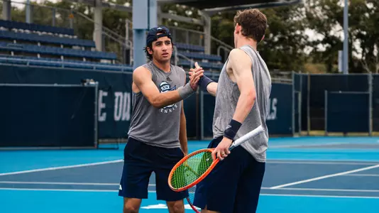 Rice men's tennis juniors Eduardo Morais (left) and Arthus de la Bassetiere (right) celebrate after a point during a recent doubles match