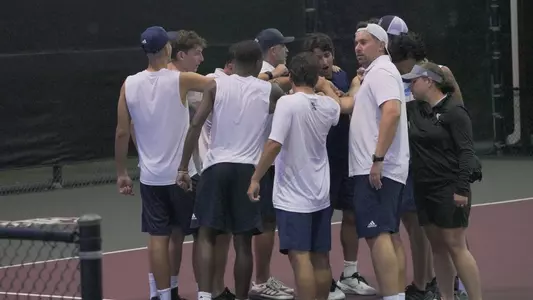 Rice men's tennis huddles following their first round match of the 2024 NCAA Championship against Texas A&M