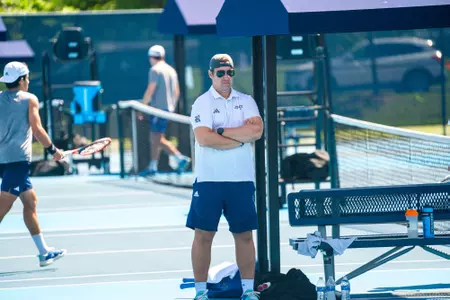 Rice assistant men's tennis coach Juuso Laitinen stands on the sideline during the team's 2024 Senior Day match against Creighton