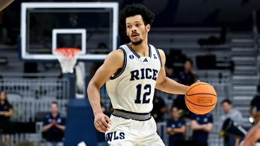 Feb 2, 2025; Houston, Texas, USA; Rice Owls guard Trae Broadnax (12) looks to pass the ball during the second half against the Memphis Tigers at Tudor Fieldhouse. Mandatory Credit: Maria Lysaker-Rice Athletics