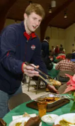 Men's Basketball Volunteers With CARITAS Tuesday