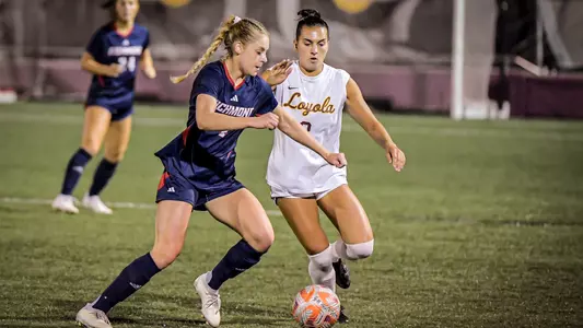 Sutton Dribbling past a Loyola Chicago Defender