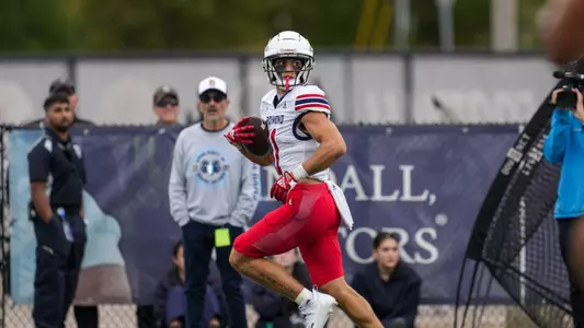 Nick DeGennaro looks over his shoulder as he runs into the end zone.