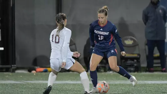 Hannah Antonick dribbling towards a Loyola Chicago Player