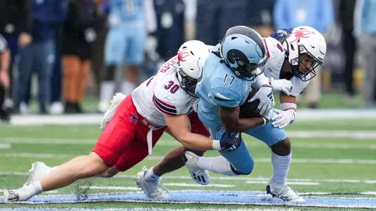 Tristan Wheeler and Aaron Banks make a tackle during Richmond's 24-17 upset win over #22 Rhode Island on Oct. 14, 2023