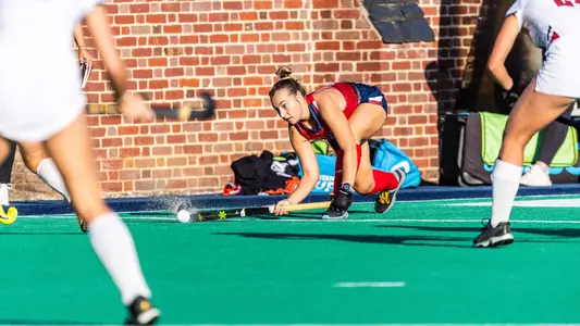 Alexa Derr sweeps the ball down field between two defenders