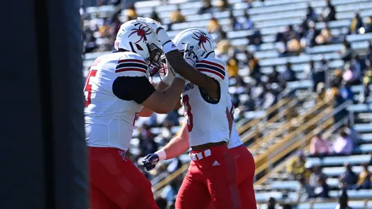 Quanye Veney and Gavin Lamp embracing in the end zone following the opening touchdown score from Veney