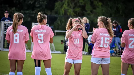 Photo of Emma Shields doing heart hands before a game