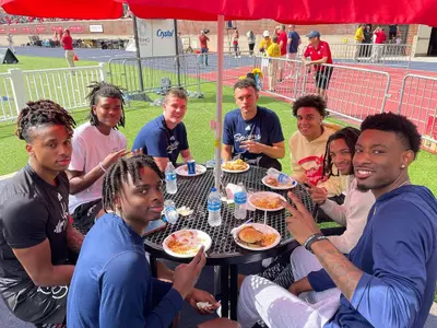 Spiders gather at a picnic table during the football game vs Hampton