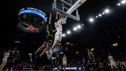 Isaiah Bigelow dunks from the baseline over a Siena defender.
