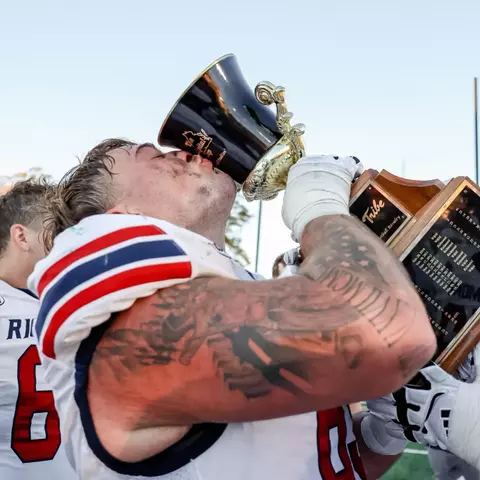 Ryan Coll kissing the Capital Cup trophy