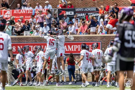 Will Tazewell jumps into a teammate in celebration during the Atlantic 10 title game in 2023