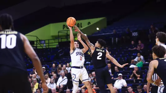 Jordan King shoots a jumpshot over a Colorado defender