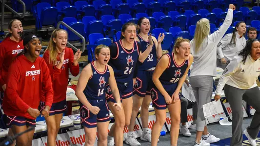 Faye Parker Ally Sweeney and Addie Budnik celebrating on the sideline during a game