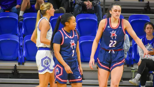 Photo of Grace Townsend and Rachel Ullstrom during a basketball game versus Drake