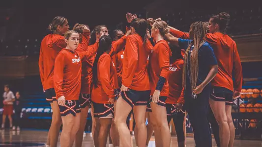 WBB team huddled together before playing Duke