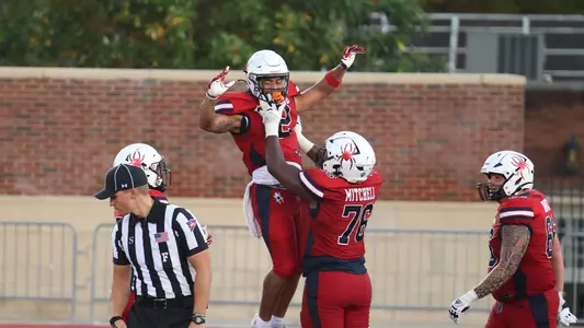 Parker Mitchell raises Savon Smith in celebration during Richmond's 44-13 homecoming win over Campbell, Oct. 28, 2023