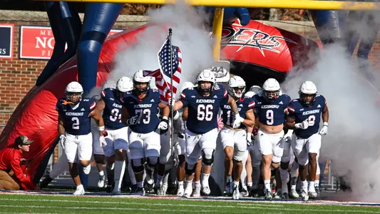 Keith Gouveia leads the University of Richmond football team out of the tunnel during its game against Elon on Oct. 11, 2023