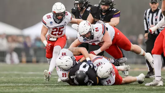 Spiders swarm a UAlbany player for a tackle during Richmond's 41-13 loss in the second round of the FCS playoffs Saturday, Dec. 2 2023