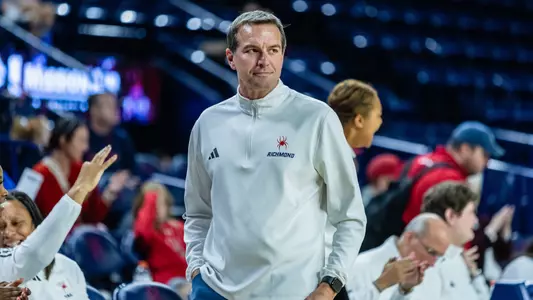 Aaron Roussell walking alongside his bench during a Women's Basketball game