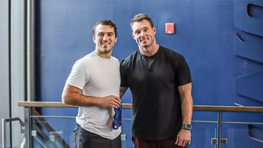 Cole Kissick and Todd Anderson hold a Dream Recovery sleep mask in Spider Hall during their discussion on December 4, 2023.