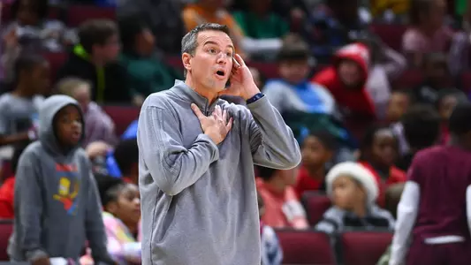 Head Coach Aaron Roussell reacts on the sideline during a game.