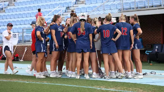 Group huddle picture of Richmond women's lacrosse team in their blue uniforms