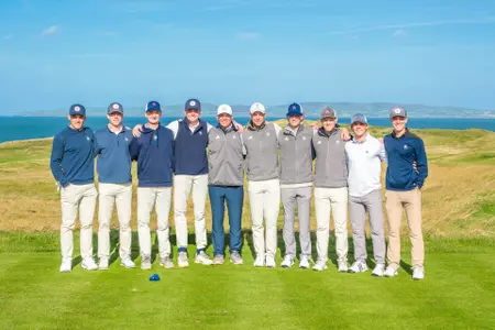 Richmond Men's Golf team posing on the first tee at Tralee Golf Club in Tralee, Ireland.