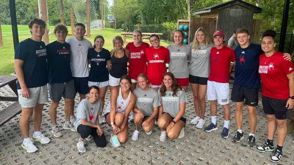 UR student-athletes pose at the ropes course on campus
