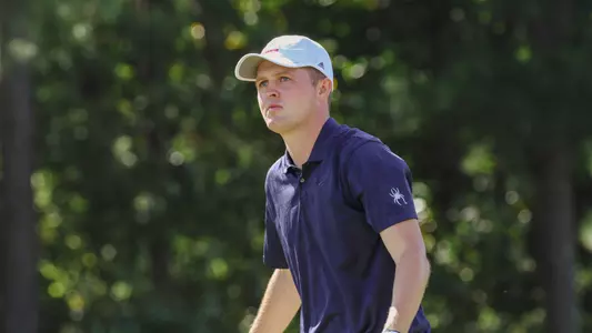 Lou Baker stares at his tee shot while beginning to walk off the tee box.