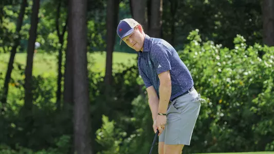 Cole Ekert watches his putt