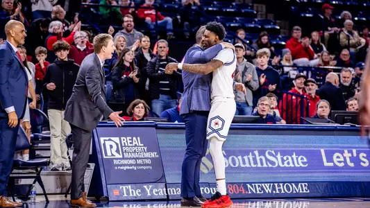 Isaiah Bigelow hugs Chris Mooney after coming out of the game vs St. Bonaventure
