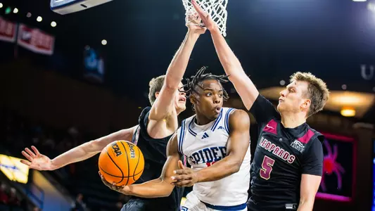 Mikkel Tyne divides Lafayette opponents under the basket, looking to pass the ball