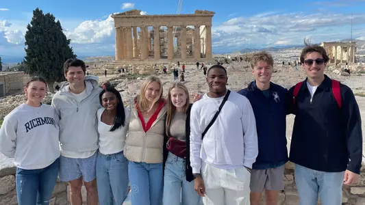 Spiders student-athletes take a group picture atop the Acropolis in Athens