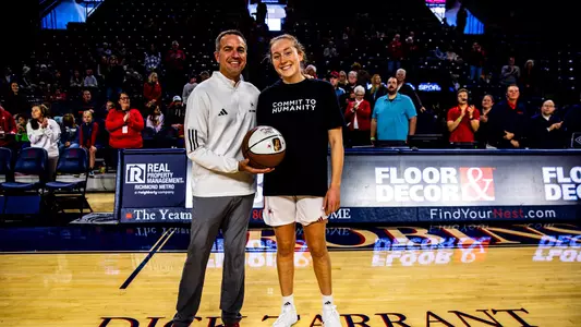 Aaron Roussell giving Addie Budnik her 1,000 point ball