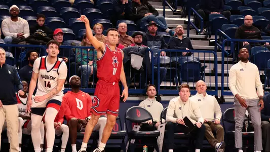 Jason Roche holds up his hand after making a three-pointer at Duquesne