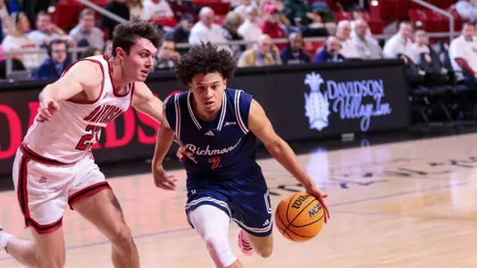 Jordan King drives through the lane at Davidson