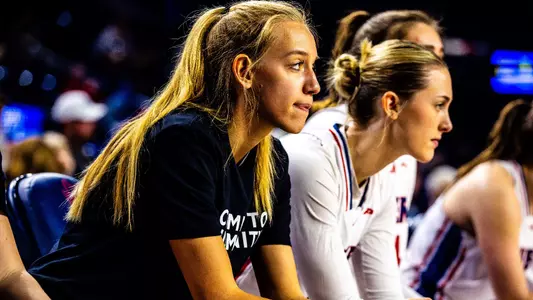 Kylee Lewandowski sitting on the bench pregame
