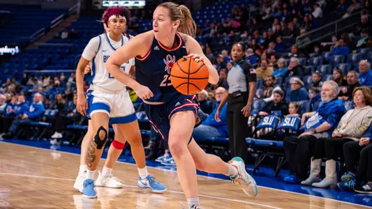 Katie Hill dribbling past a SLU defender