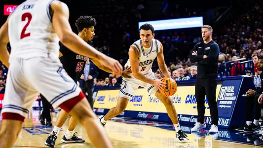 Jason Roche looks into the post to find a pass vs Lafayette
