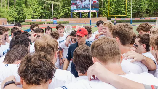 Dan Chemotti in center of team huddle