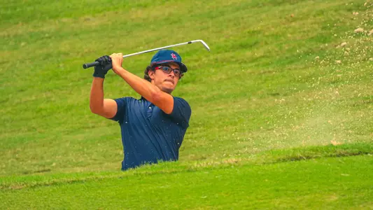 Carson Baez hits out of a bunker