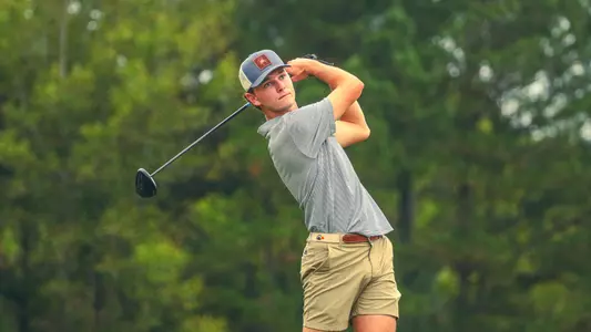 Drew Carlin holds his follow through after a tee shot